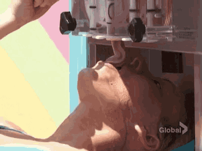 a woman is eating ice cream from a machine that says global on the bottom