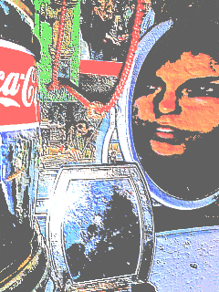 a bottle of coca cola sits on a table next to a glass