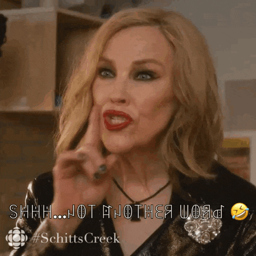 a woman is holding her finger to her lips and says shhh not another word