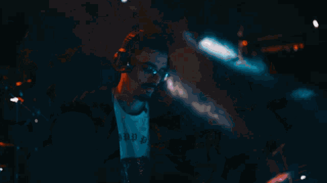 a blurry picture of a crowd at a concert with a triangle in the background