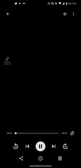 a screenshot of a music player on a cell phone with a black background .