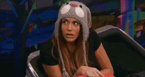 a woman wearing a knitted hat with a cat on it .