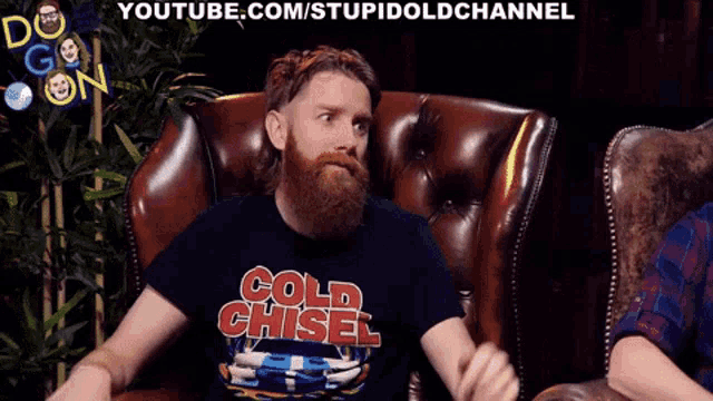 a man with a beard is wearing a black shirt that says cold chisel
