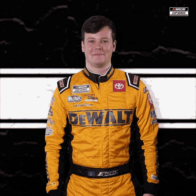 a man wearing a yellow and black dewalt racing suit