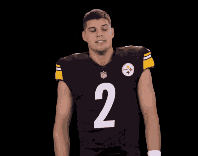 a football player wearing a black jersey with the number 2 on it