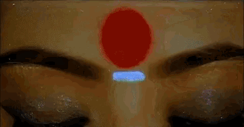 a close up of a woman 's face with a star on her forehead