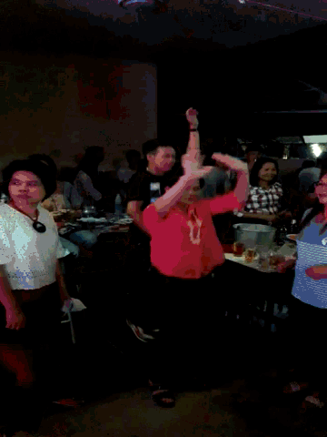 a blurry picture of a group of people sitting at tables