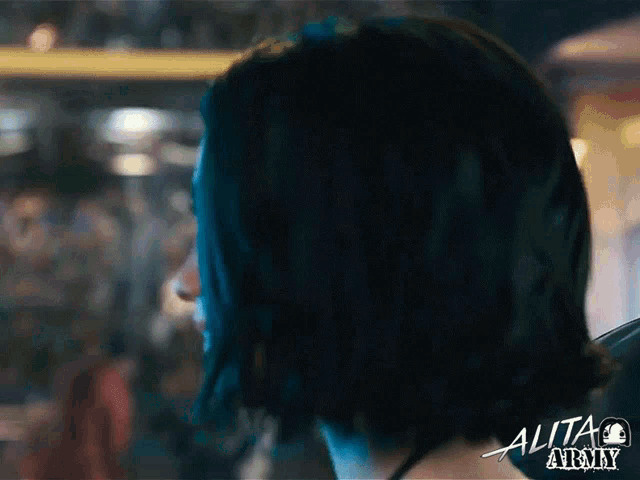 a close up of a woman 's face with the word alita army written on the bottom