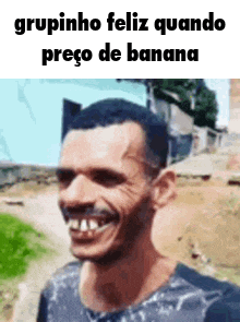 a man with a big smile on his face is standing in front of a building .
