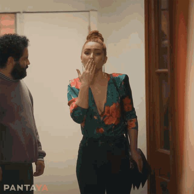 a woman covering her mouth while standing next to a man with the word pantaya on the bottom