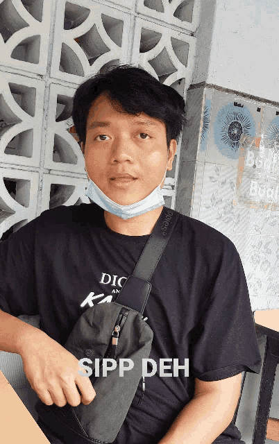 a man wearing a mask and a black shirt that says spp deh