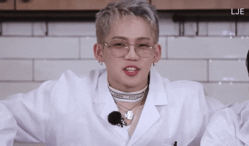 a man wearing glasses and a choker with coco on it