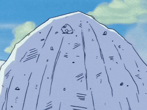 a man with a beard is standing in front of a mountain with a blue sky in the background