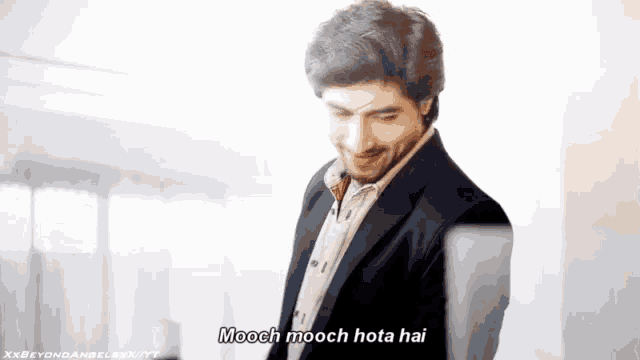 a man in a suit is saying mooch mooch mota hai