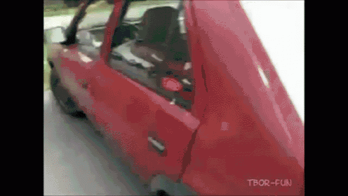 a red car is driving down a road with tbor-fun written on the bottom right