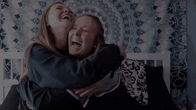 two girls are hugging and laughing with the word hi n written above them