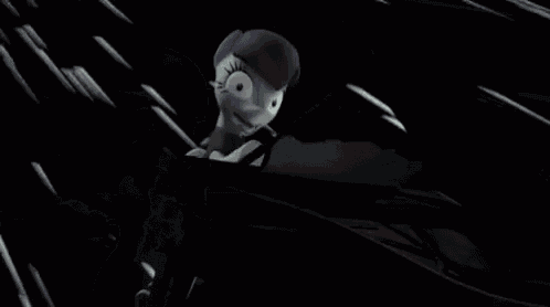 a cartoon character is standing in a dark room .