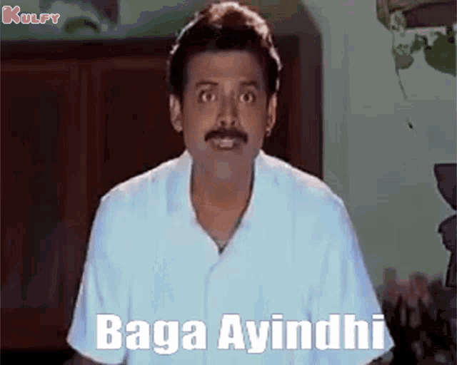 a man in a white shirt is making a funny face and says baga ayindi
