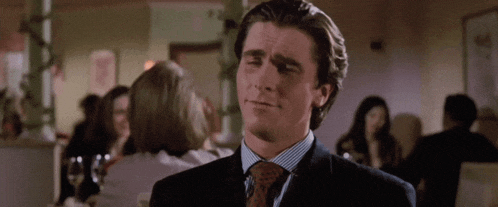 a man in a suit and tie is looking at something