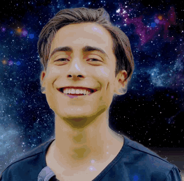 a young man is smiling in front of a starry background