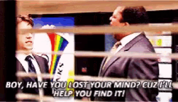 a man in a suit and tie talking to another man in a suit and tie