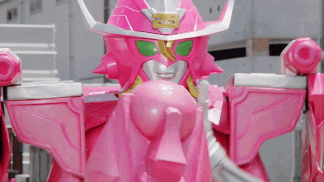 a pink robot has the number 25 on it 's head