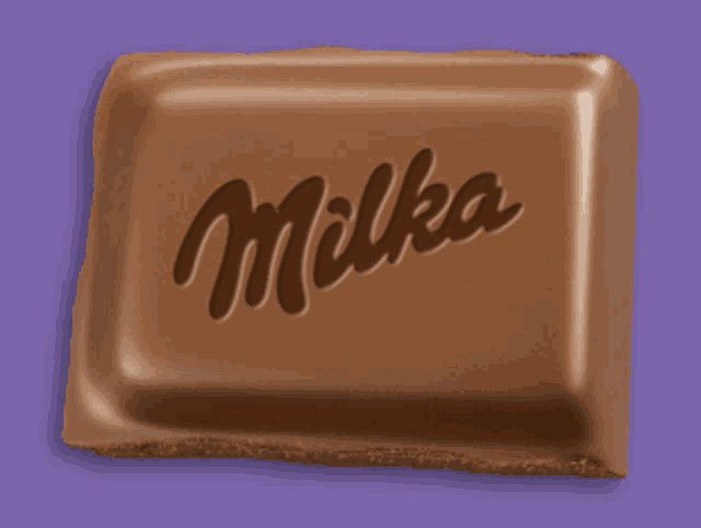 a milka chocolate bar is against a purple background