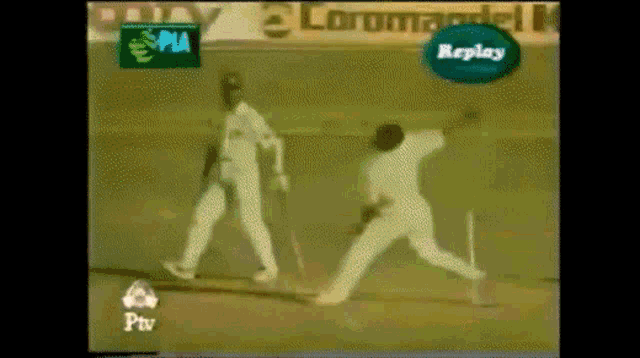 a replay sign is above a cricket player