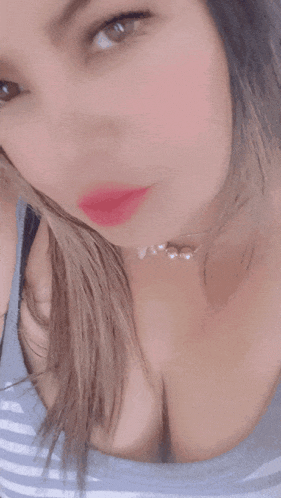 a close up of a woman 's face with a pink lip