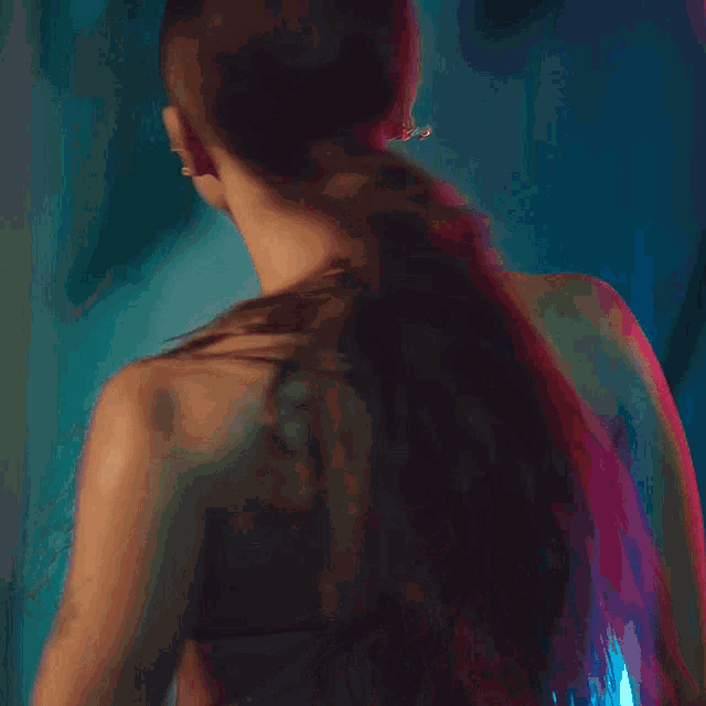 a woman with a ponytail and a nose ring