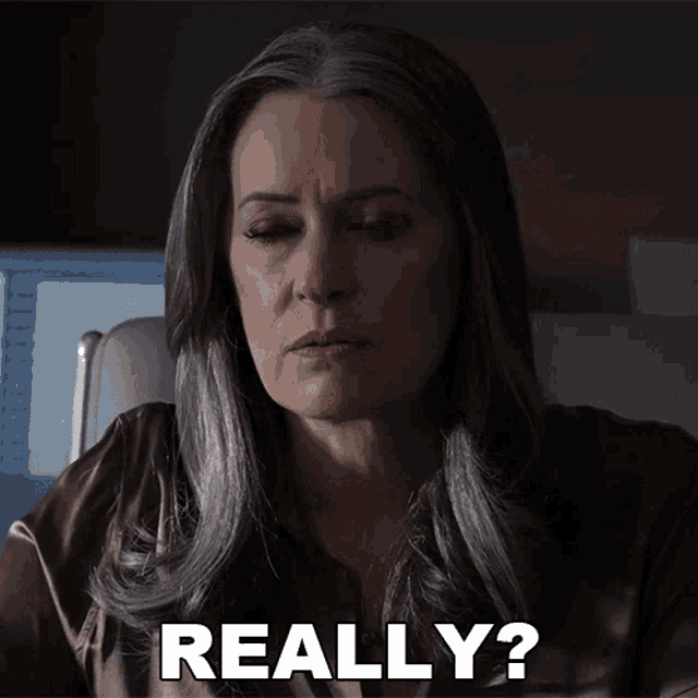 a woman with gray hair is making a face and says really