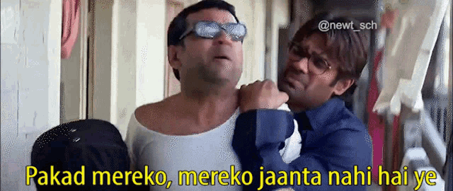 two men are standing next to each other and the caption reads " pakad mereko mereko jaanta nahi hai ye " .