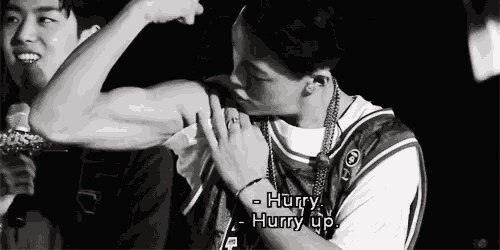 a black and white photo of a man holding another man 's arm with the words hurry hurry up visible