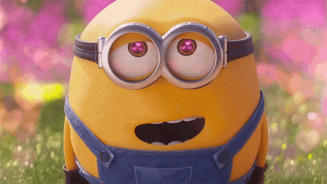 a close up of a minion 's face with hearts in his eyes