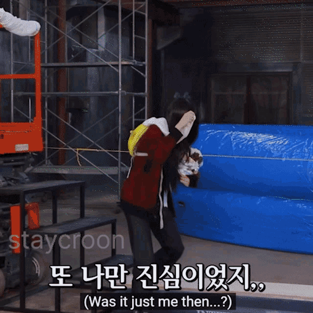 a woman in a red jacket is holding a dog and says " was it just me then " in a foreign language