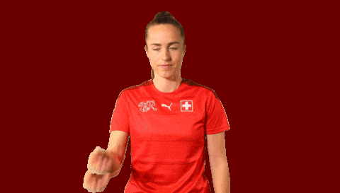 a woman wearing a red puma shirt with a swiss cross on it