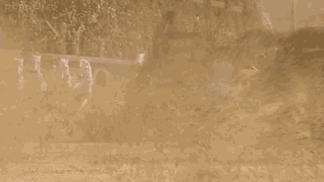 a man is running through a dust storm with the name ben-mur on the bottom of the screen