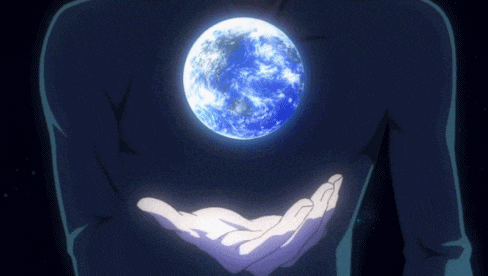 a person is holding a blue planet in their hand