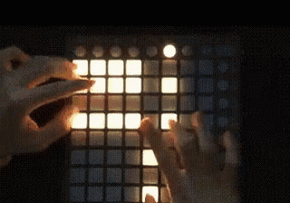 a close up of a person playing a keyboard with a light shining on the keys