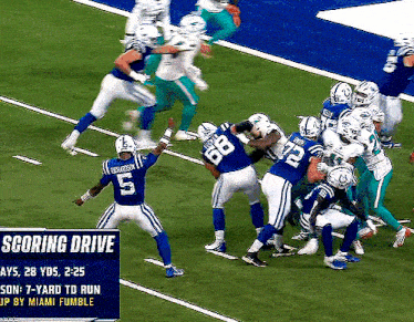 a football player with the number 5 on his jersey is being tackled
