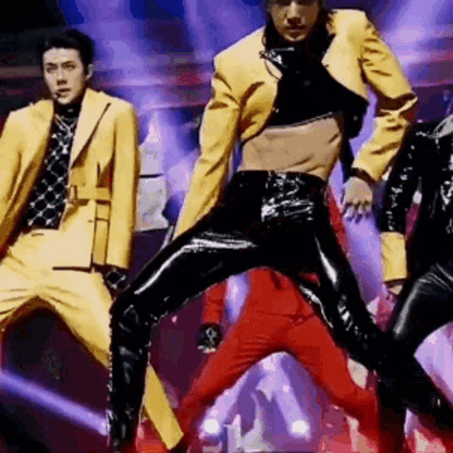 a group of men are dancing on a stage .