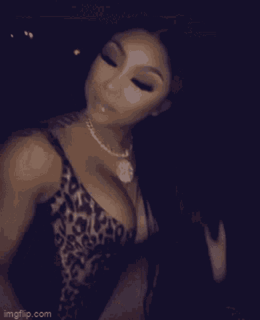 a woman is wearing a leopard print bra and a necklace