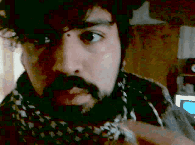 a man with a beard and a scarf around his neck