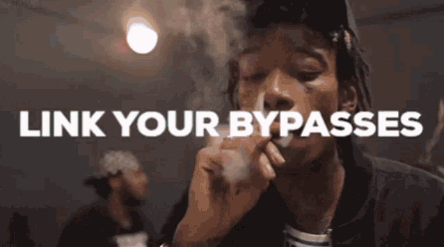 a man is smoking a cigarette in a room with the words `` link your bypasses '' above him .