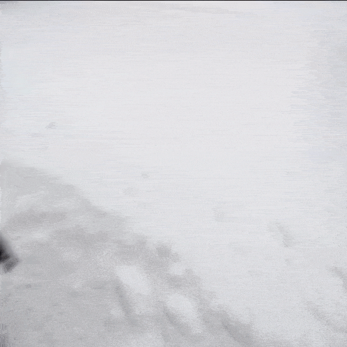 a person wearing a helmet and gloves is walking in the snow