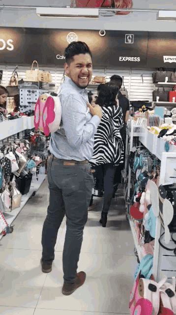 a man in a store with a butterfly backpack