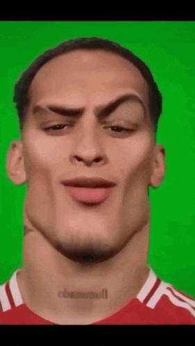 a close up of a man 's face with a green screen in the background