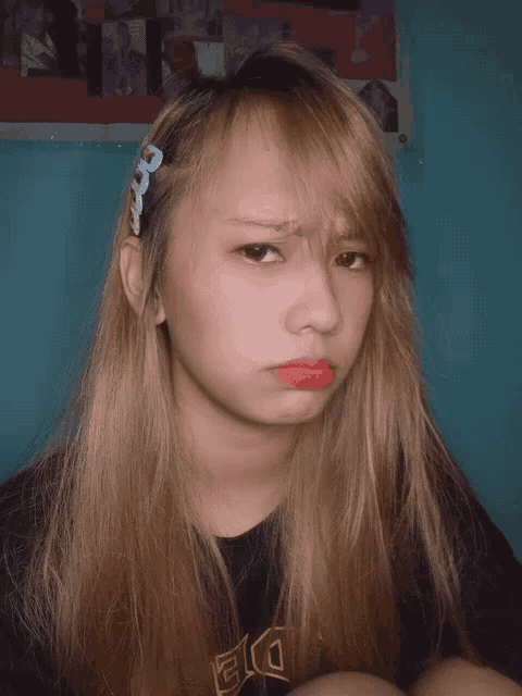 a girl with blonde hair wearing a black shirt with the word die on it