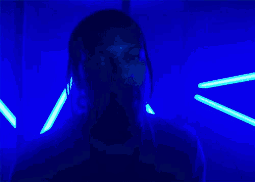 a person in a dark room with glow in the dark lights