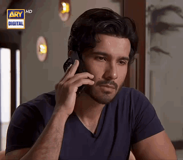 a man talking on a cell phone with ary digital written in the corner